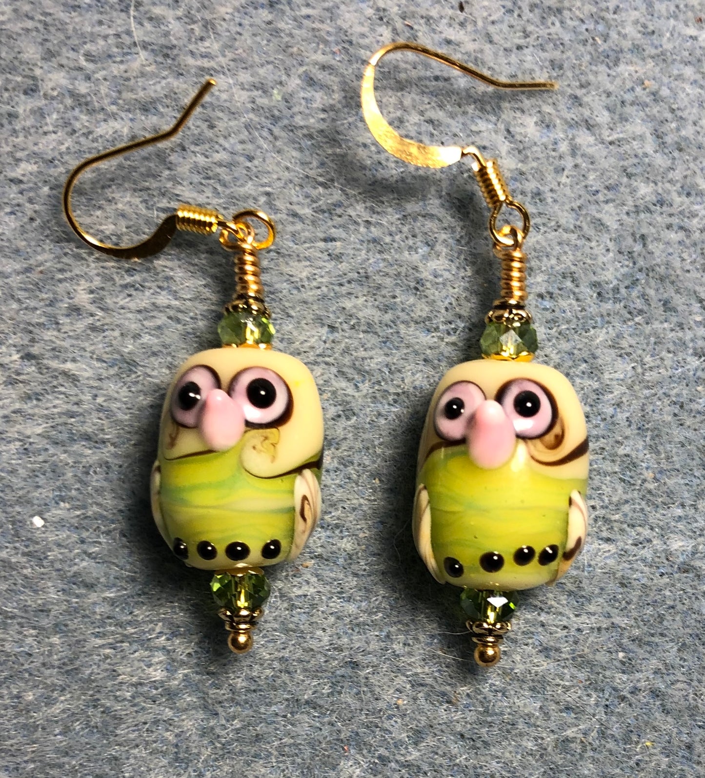 Lime green and pink lamp work owl bead earrings adorned with lime green Chinese crystal beads.