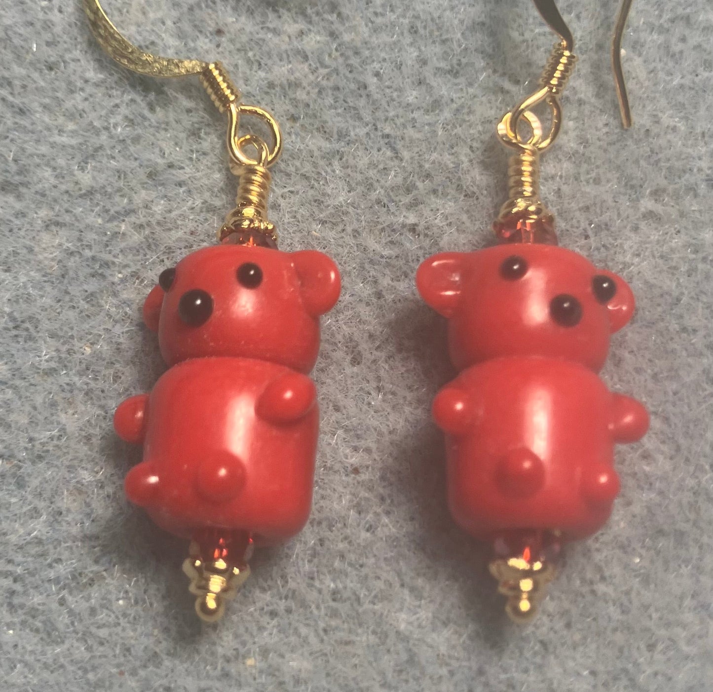 Small red lamp work teddy bear bead earrings adorned with red Chinese crystal beads.