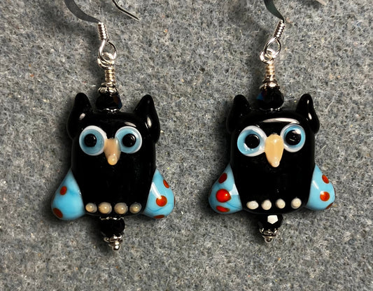 Black and blue lamp work owl bead earrings adorned with black Chinese crystal beads.