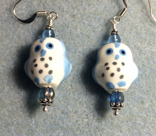 Light blue and white ceramic spotted owl bead earrings adorned with blue Czech glass beads.