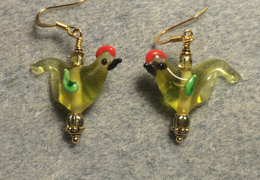 Translucent yellow green red crested lamp work songbird bead earrings adorned with yellow green Czech glass beads.