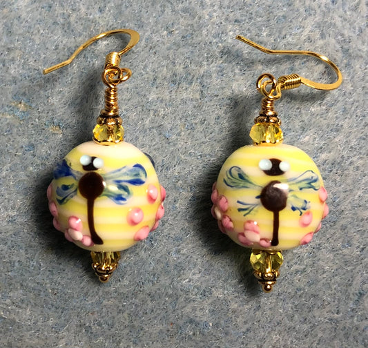 Yellow, blue, and pink lamp work dragonfly bead earrings adorned with yellow Chinese crystal beads.