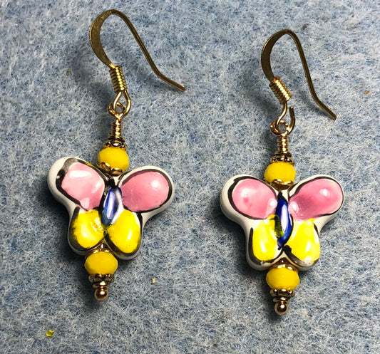 Pink and yellow ceramic butterfly bead earrings adorned with yellow Chinese crystal beads.