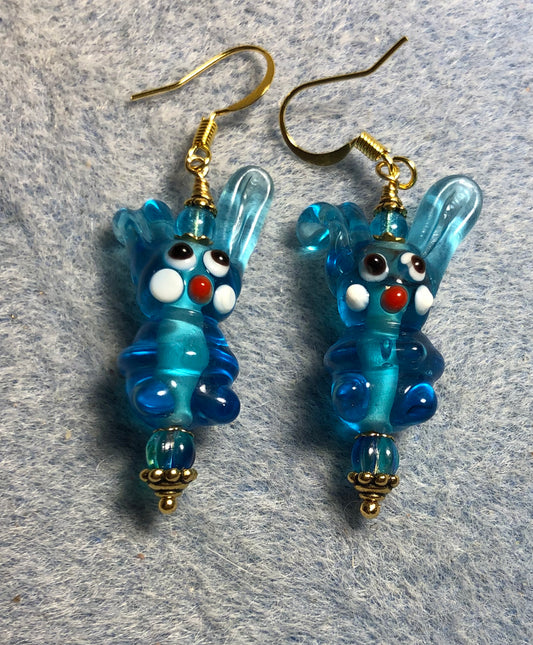 Translucent turquoise lamp work bunny rabbit bead earrings adorned with turquoise Czech glass beads.