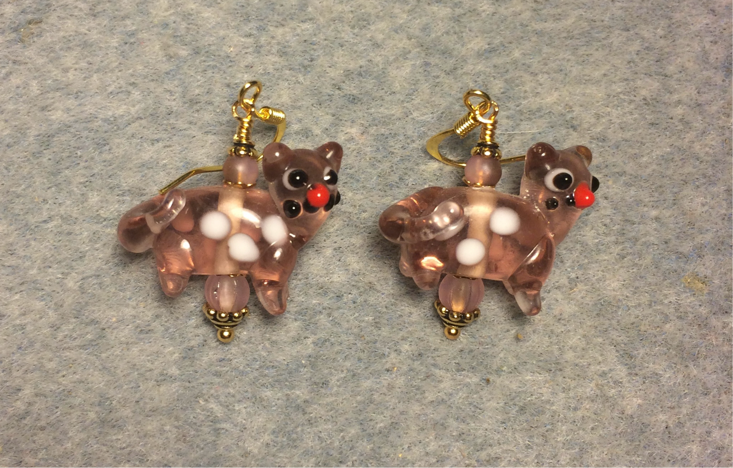 Translucent rose pink lamp work spotted cat bead earrings adorned with rose pink Czech glass beads.