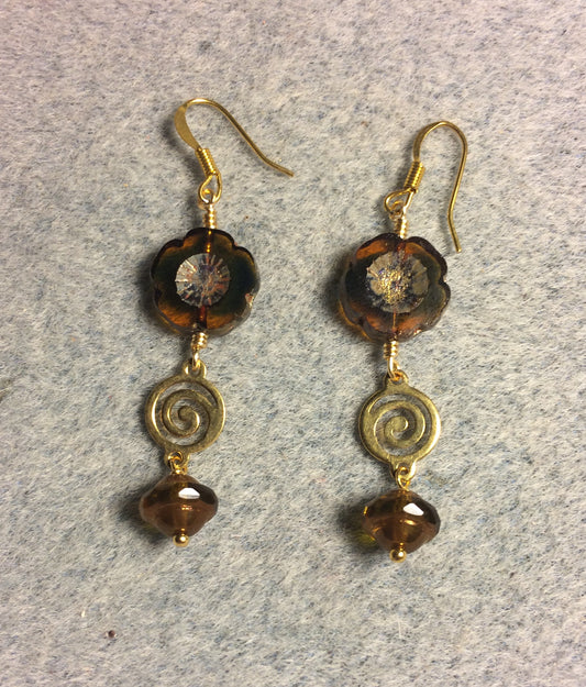 Brown and green Czech glass pansy bead earrings adorned with gold swirly connectors and brown Czech glass Saturn beads.