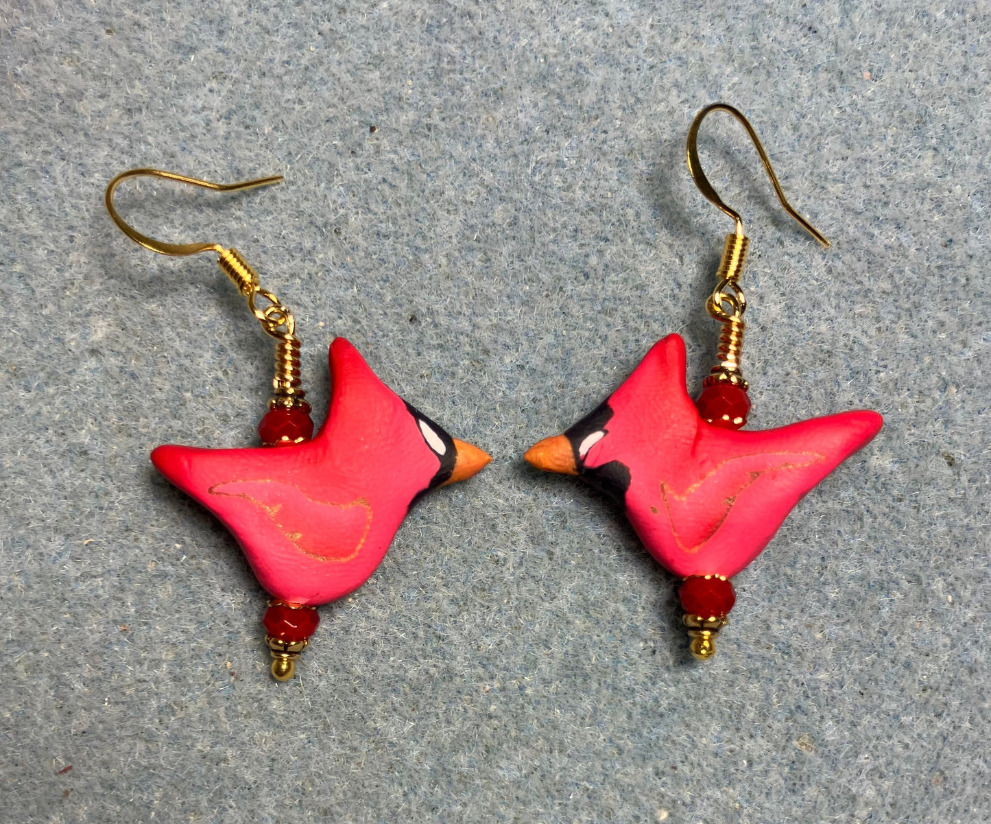 Red polymer clay cardinal bead earrings adorned with red Chinese crystal beads.