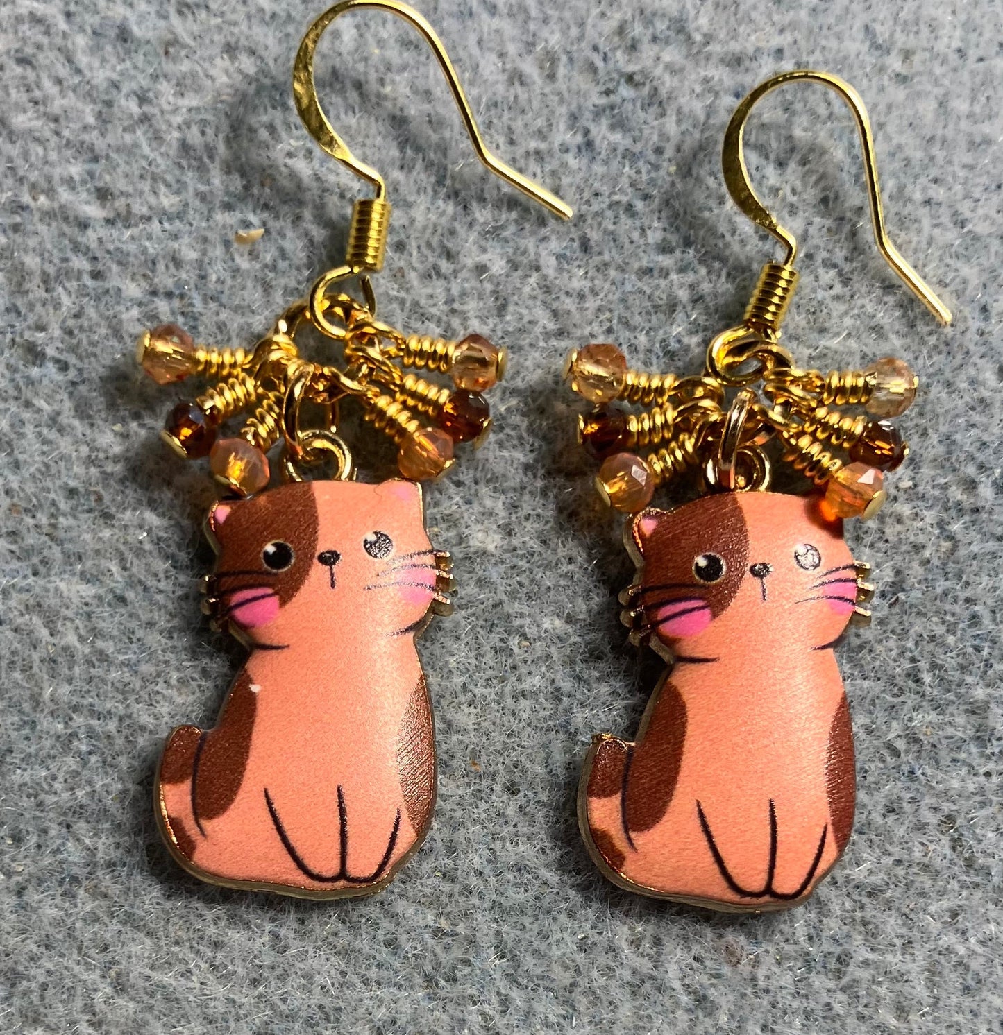 Orange and brown enamel cat charm earrings adorned with tiny dangling orange and brown Chinese crystal beads.