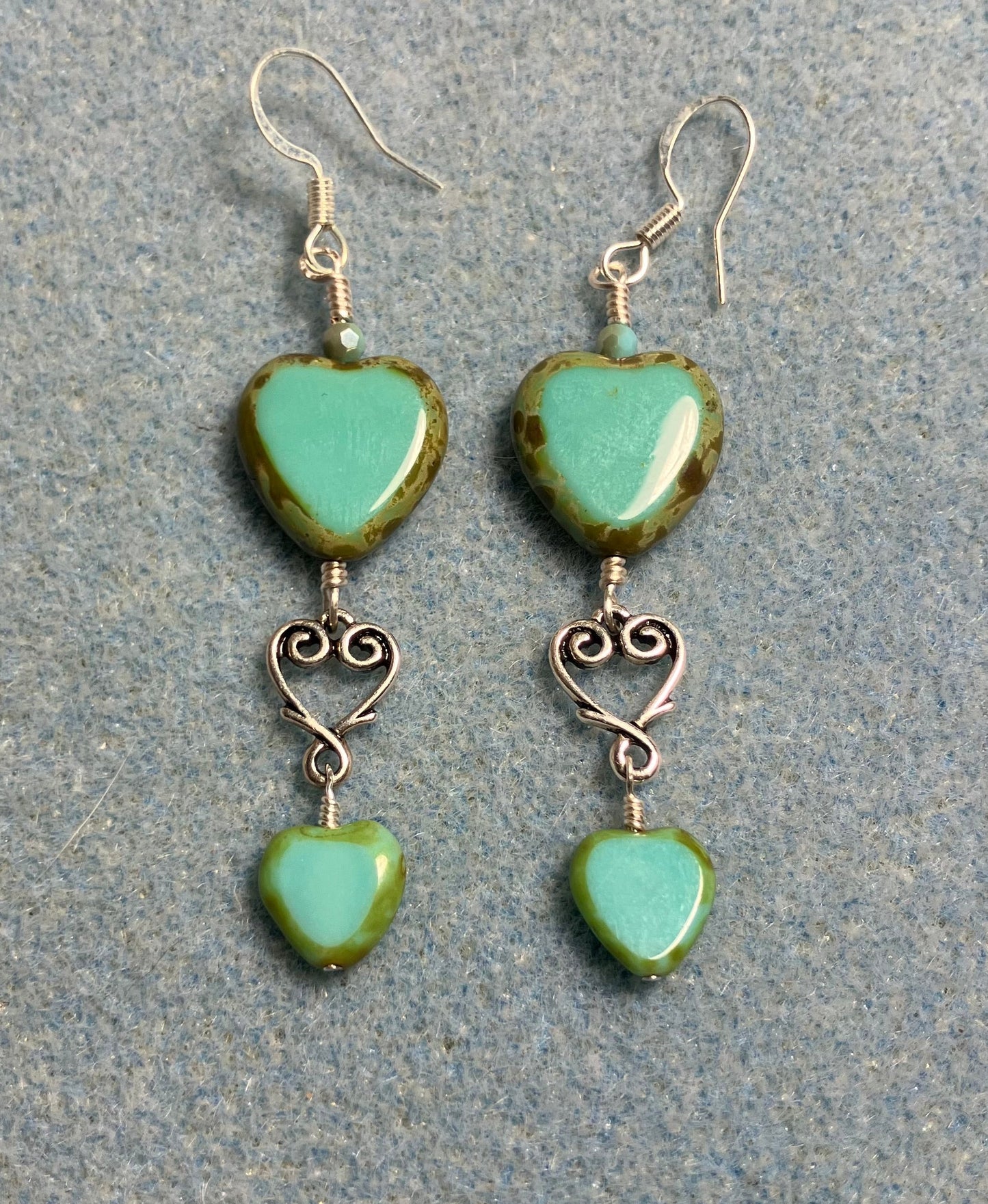 Large and small matching opaque turquoise Czech glass heart bead earrings joined by silver Tierracast heart connectors.