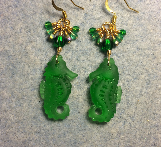 Emerald green sea glass seahorse pendant bead earrings adorned with emerald green Czech glass beads and small dangling emerald green Czech glass beads.