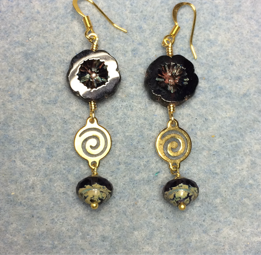 Dark purple Czech glass pansy bead earrings adorned with gold swirly connectors and dark purple Czech glass Saturn beads.