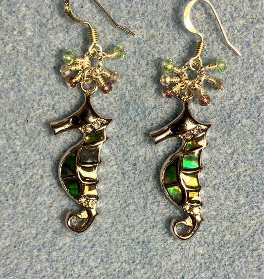 Silver and abalone seahorse charm earrings adorned with small dangling light green, silver, and violet Chinese crystal beads.