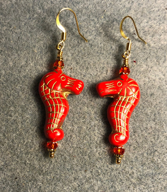 Bright red (with gold inlay) Czech glass seahorse bead earrings adorned with bright red Chinese crystal beads.