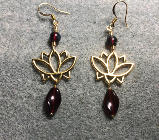 Gold lotus flower connector charm earrings adorned with dark red Czech glass twist beads and dark red Czech glass beads.