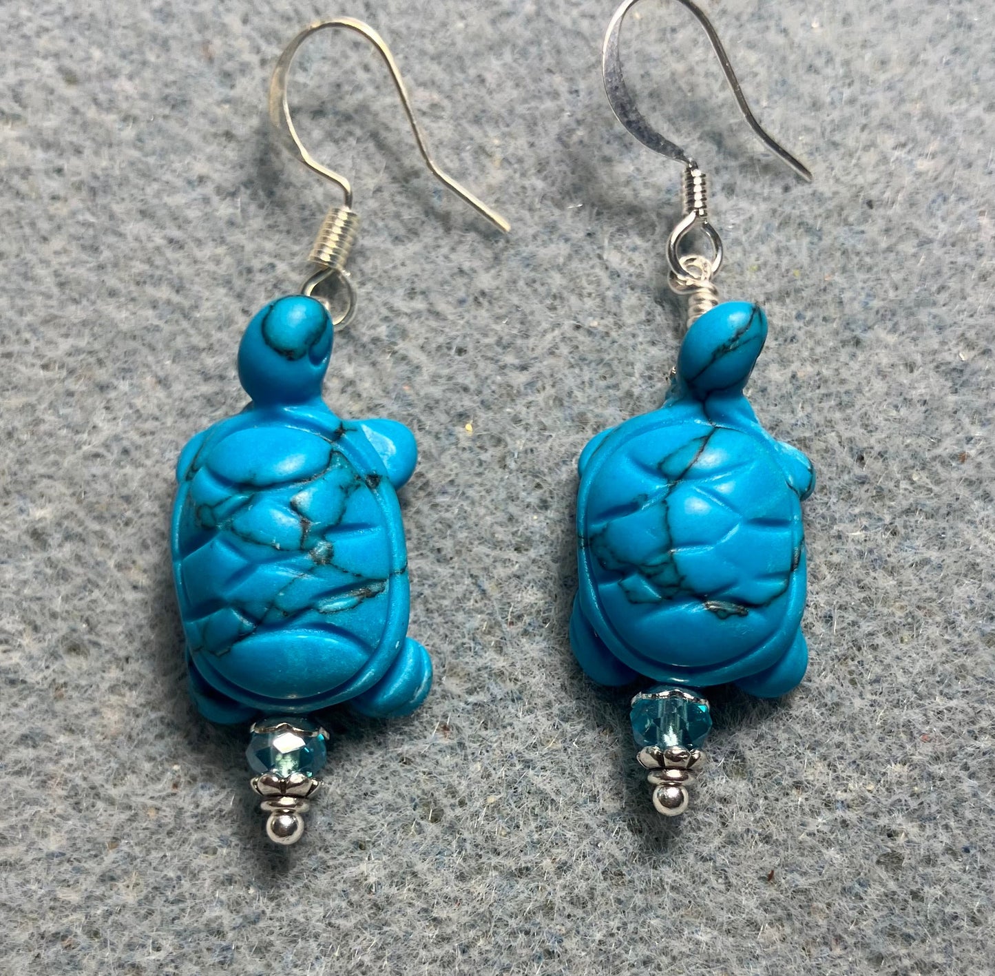 Turquoise howlite gemstone turtle bead earrings adorned with turquoise Chinese crystal beads.