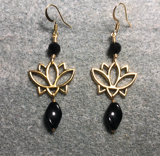 Gold lotus flower connector charm earrings adorned with black Czech glass twist beads and black Czech glass beads.