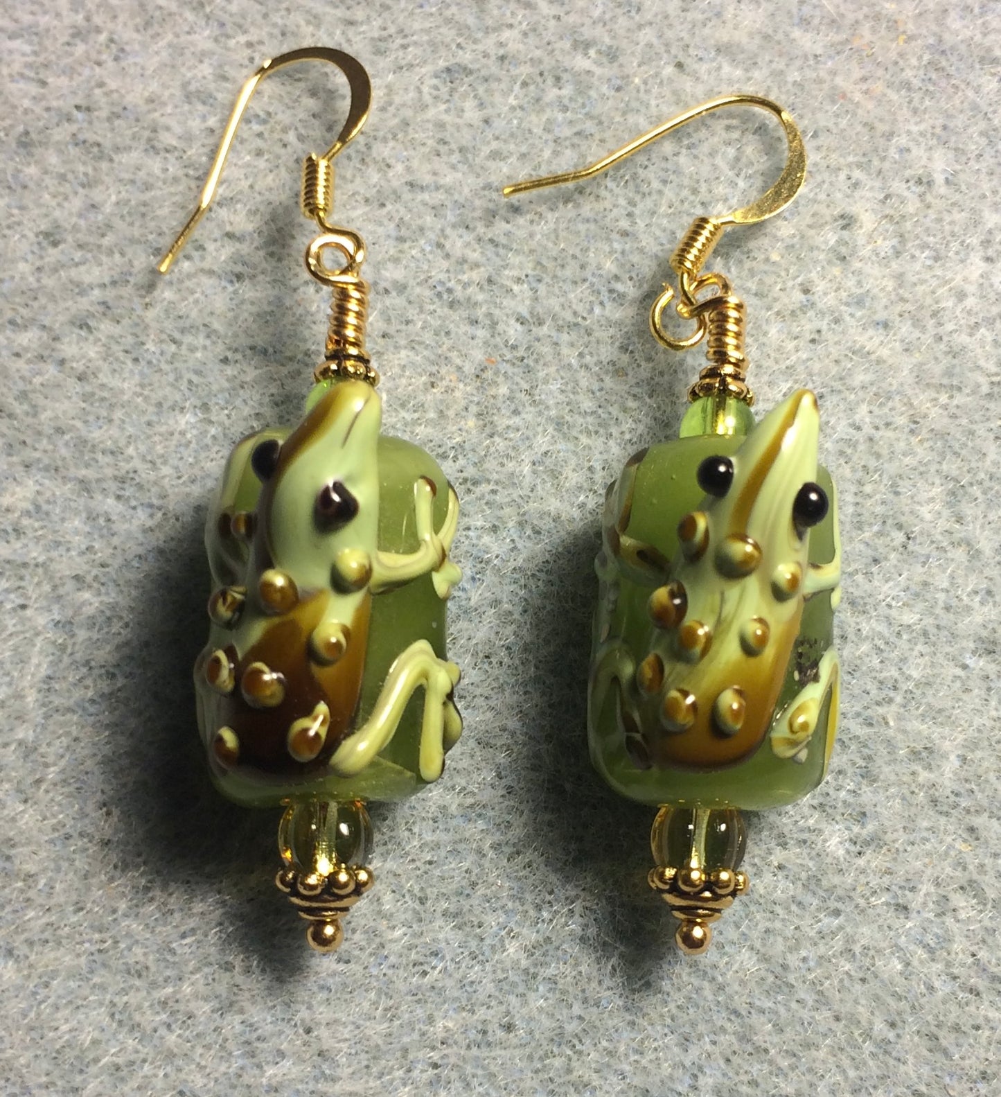 Olive green and brown lamp work lizard bead earrings adorned with olive green Czech glass beads.