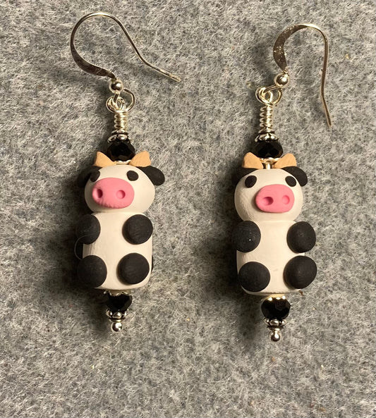 Small black, white and pink polymer clay cow bead earrings adorned with black Chinese crystal beads.