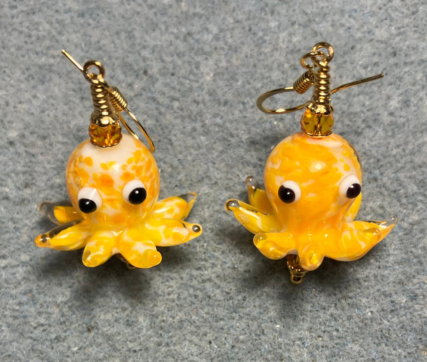 Tangerine and white mottled lamp work octopus bead earrings adorned with tangerine Chinese crystal beads.