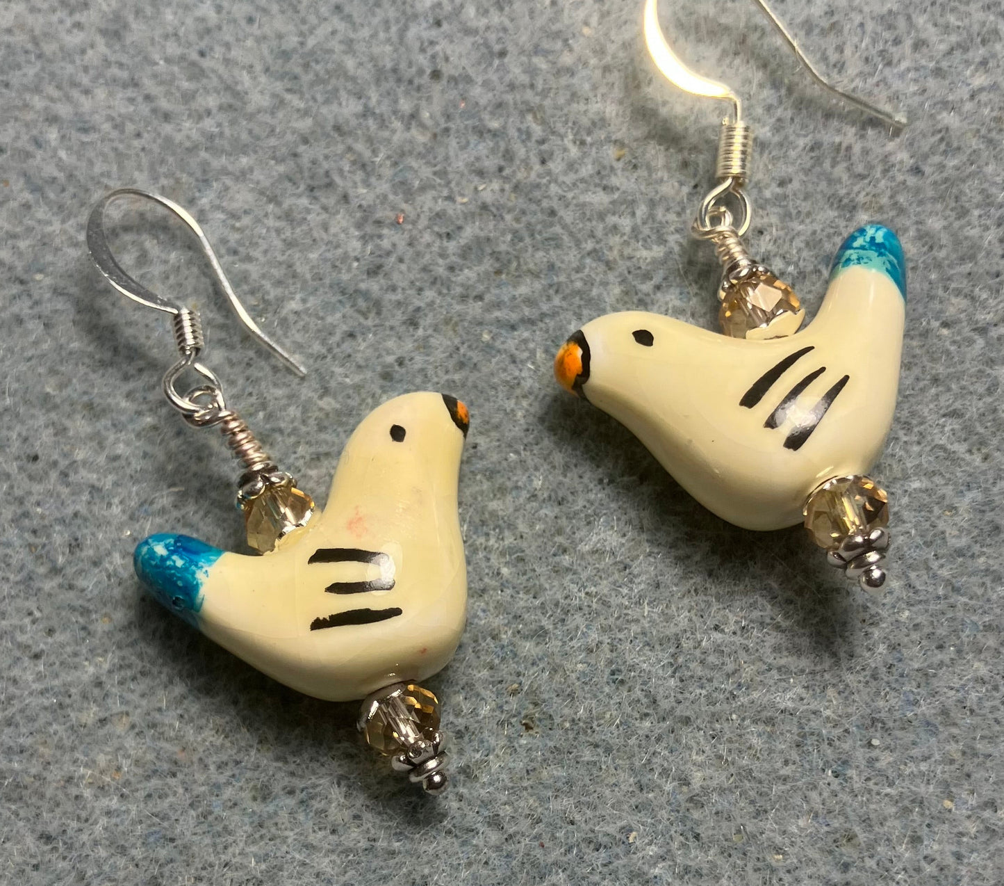 Small light yellow and turquoise ceramic bird bead earrings adorned with light yellow Chinese crystal beads.