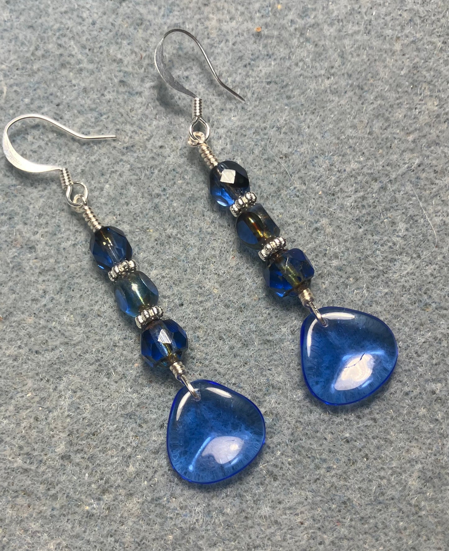 Translucent dark blue Czech glass rose petal earrings adorned with dark blue Czech glass beads.
