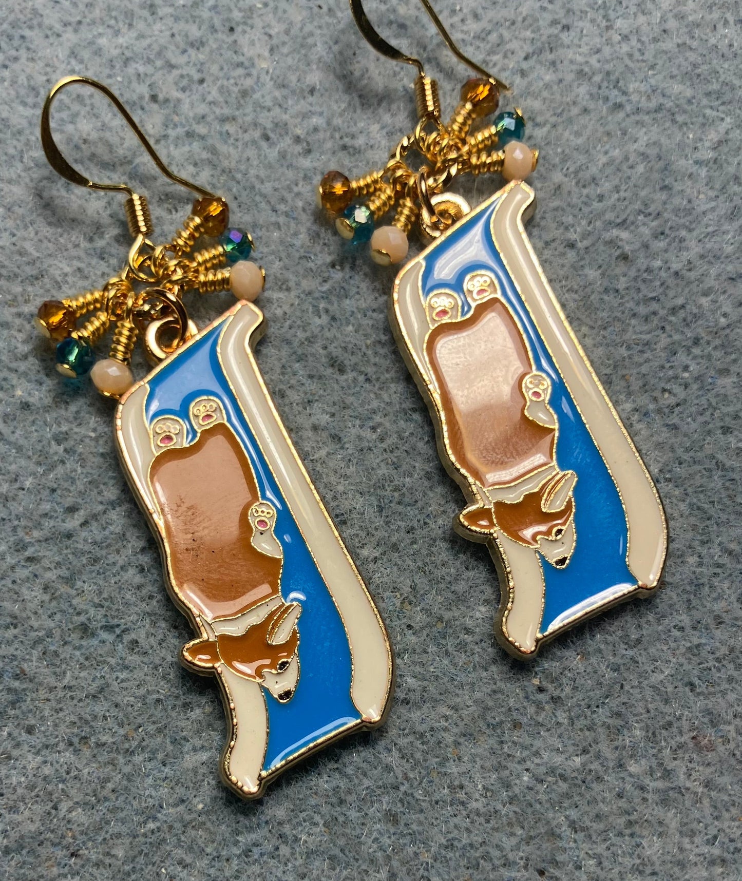 Brown and white enamel corgi charm earrings adorned with tiny dangling white, blue, and amber Chinese crystal beads.