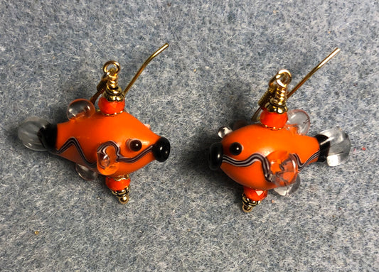 Orange and black lamp work fish bead earrings adorned with orange Chinese crystal beads.