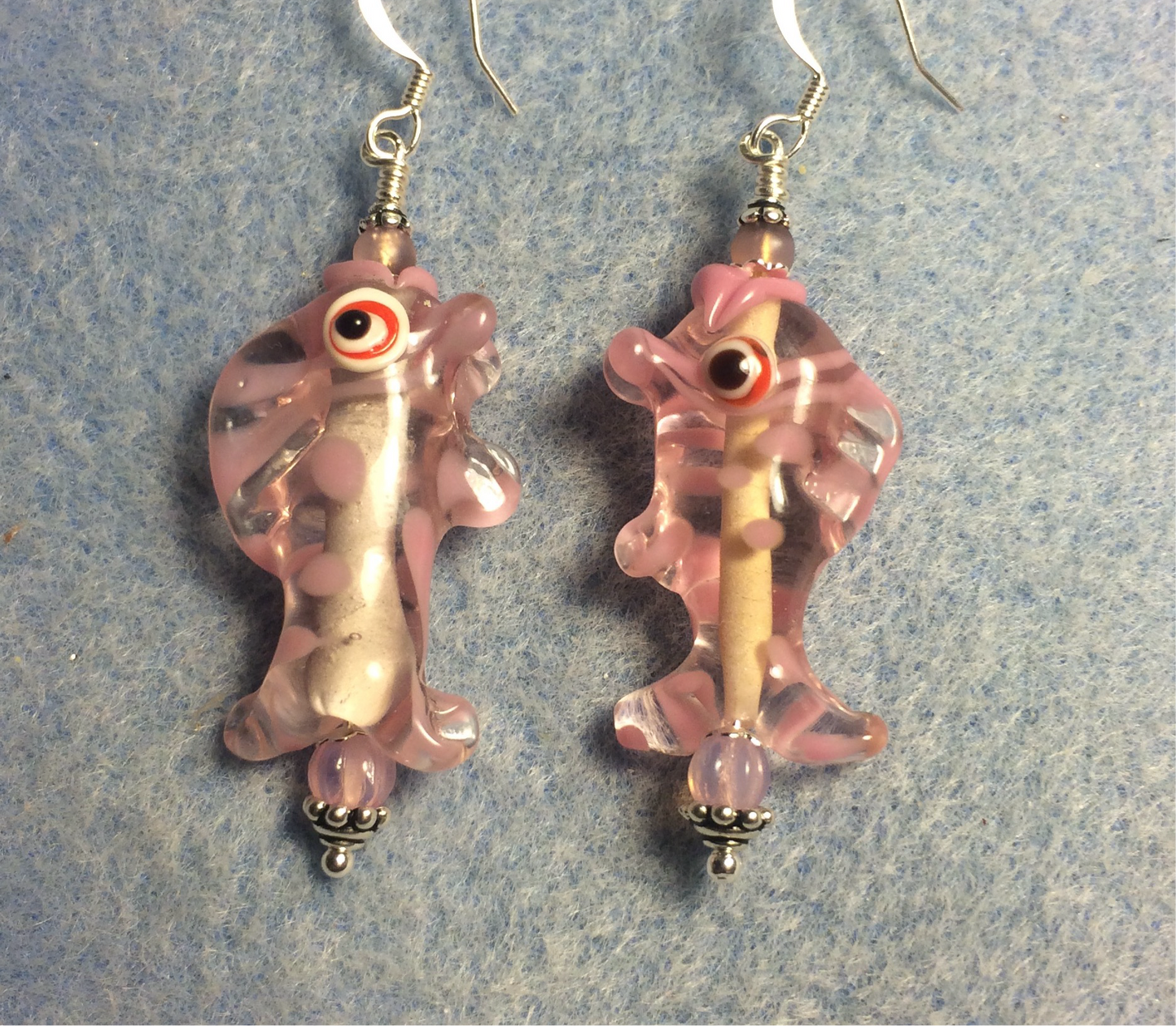 Pink and clear lamp work fish bead earrings adorned with pink Czech glass beads.