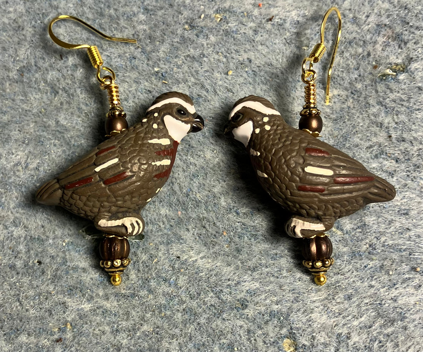 Large brown and white ceramic partridge bead earrings adorned with brown Czech glass beads.