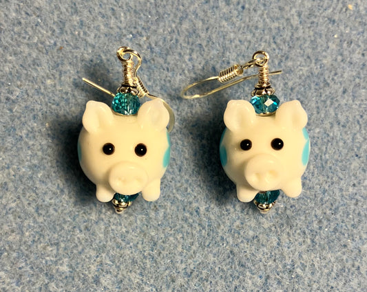 Small white and turquoise lamp work pig bead earrings adorned with turquoise Chinese crystal beads.