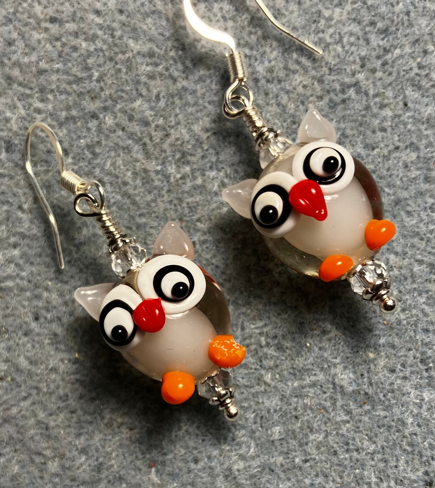 Clear, orange, and red lamp work owl bead earrings adorned with clear Chinese crystal beads.