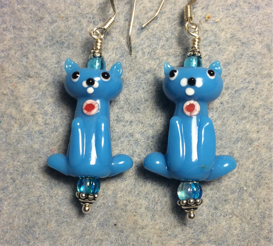 Opaque turquoise lamp work cat bead earrings adorned with turquoise Czech glass beads.