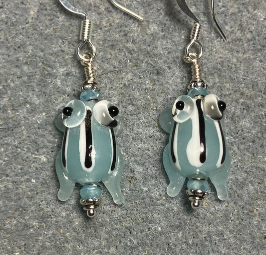 Very small translucent light blue with black stripes lamp work frog bead earrings adorned with light blue Chinese crystal beads.