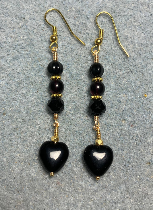 Small black Czech glass heart bead earrings adorned with black Czech glass beads.