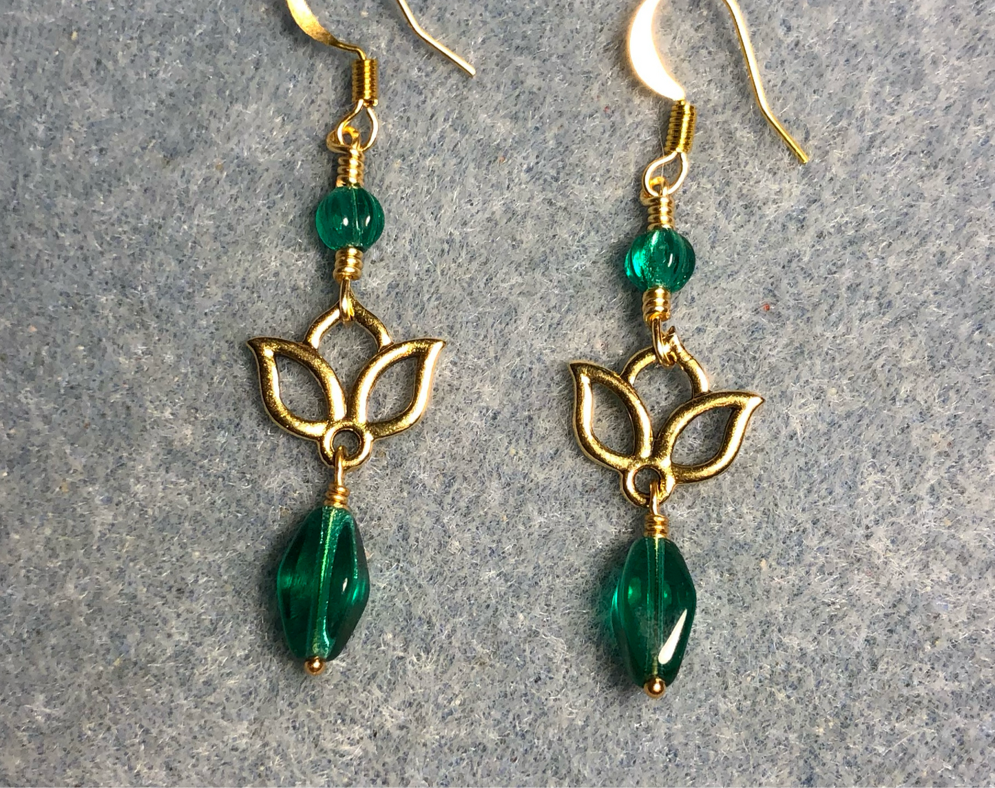 Small gold lotus flower connector charm earrings adorned with teal Czech glass drop beads and teal Czech glass melon beads.