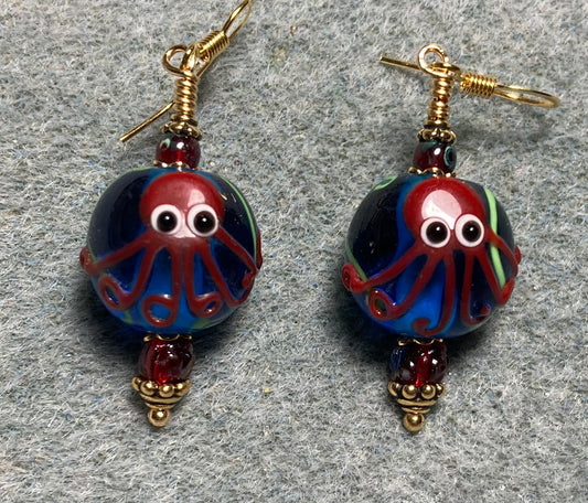 Blue and dark red lamp work octopus bead earrings adorned with dark red Czech glass beads.
