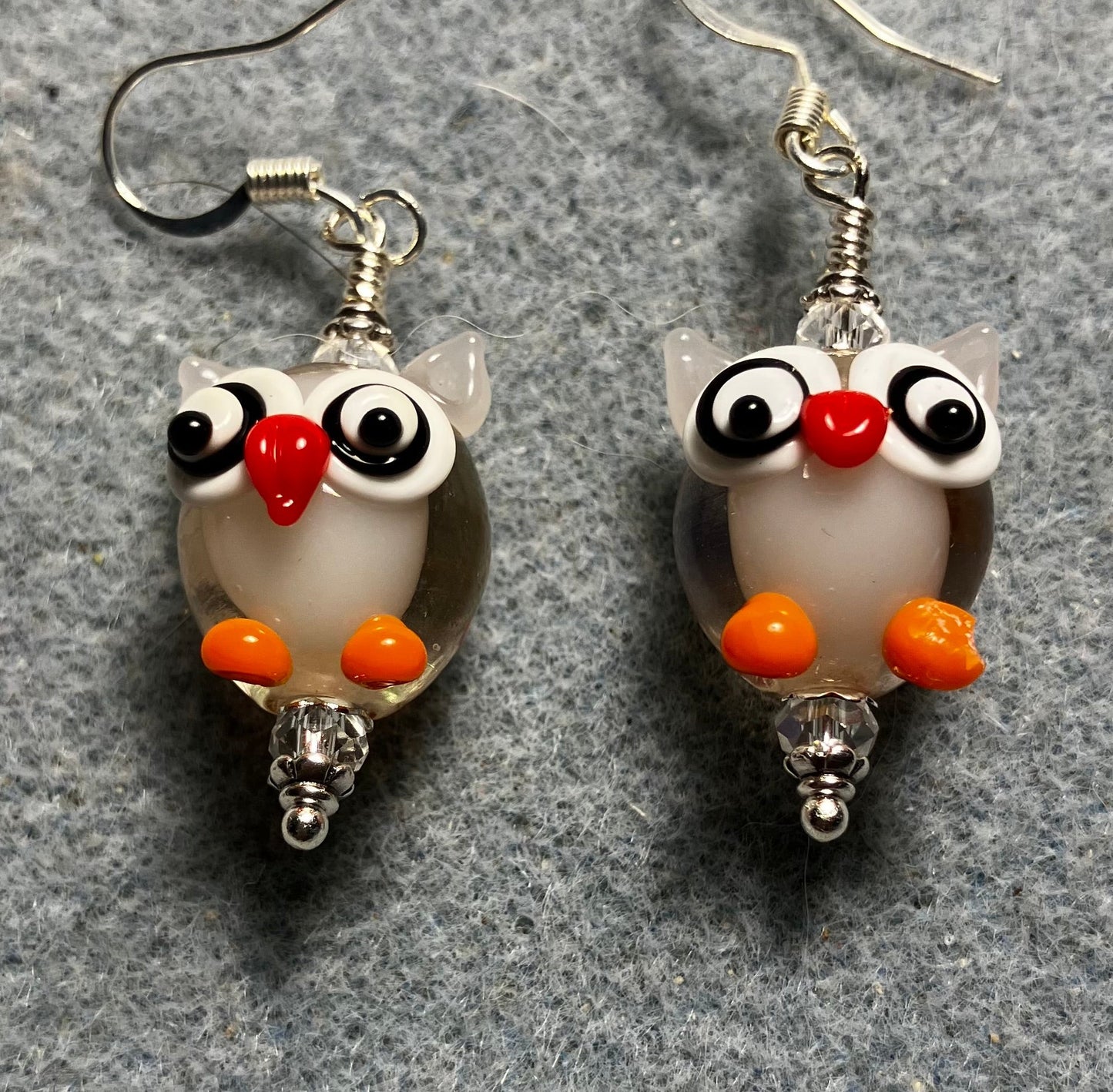 Clear, orange, and red lamp work owl bead earrings adorned with clear Chinese crystal beads.
