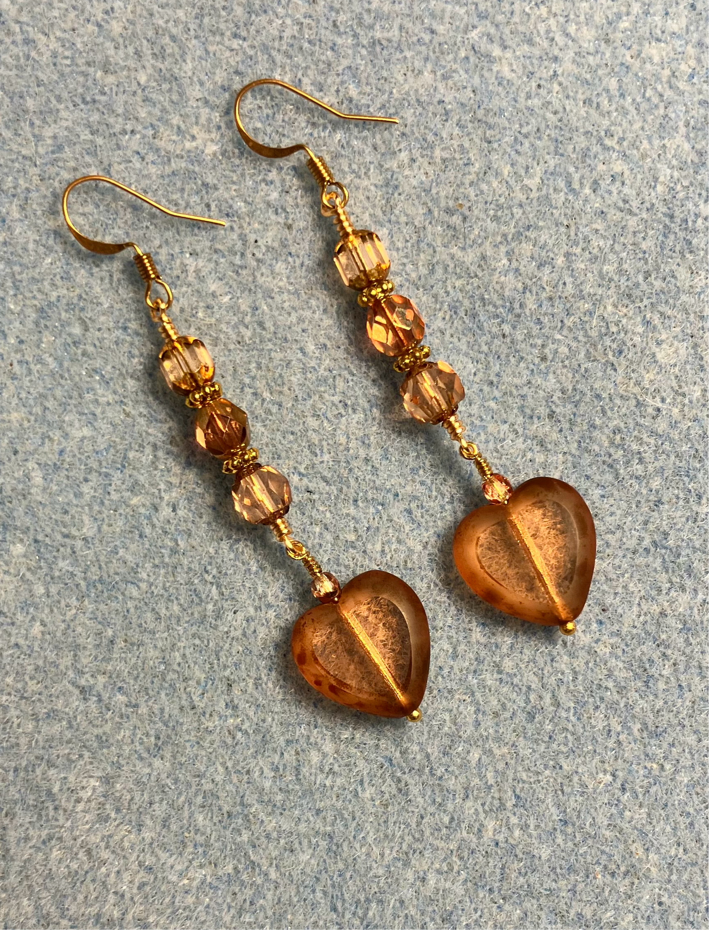 Peach Czech glass heart bead earrings adorned with peach Czech glass beads.