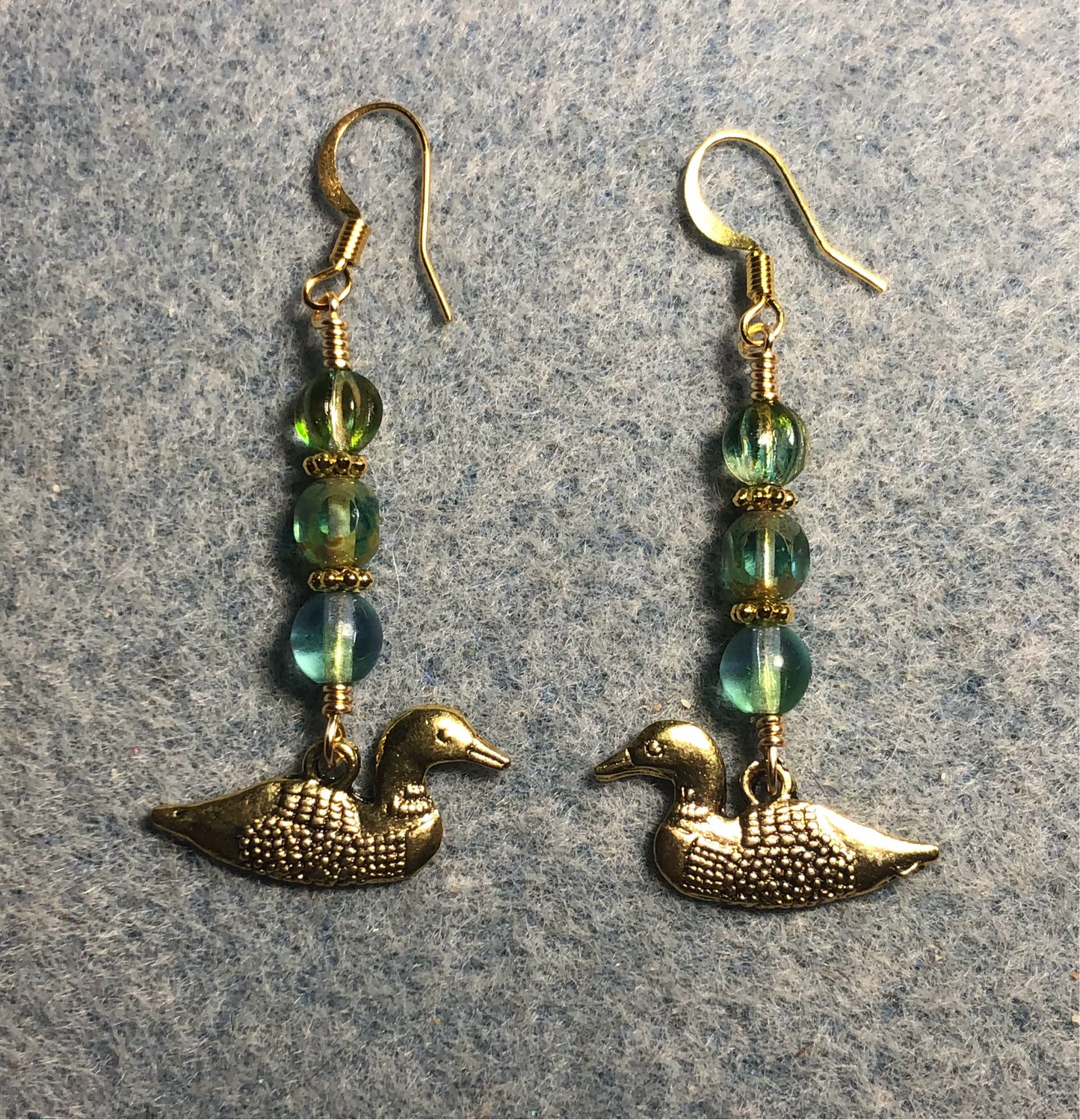 Gold mallard duck (loon) charm earrings adorned with light blue green Czech glass beads