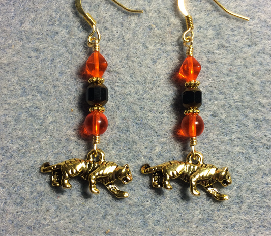 Gold tiger charm earrings adorned with black and gold Czech glass beads