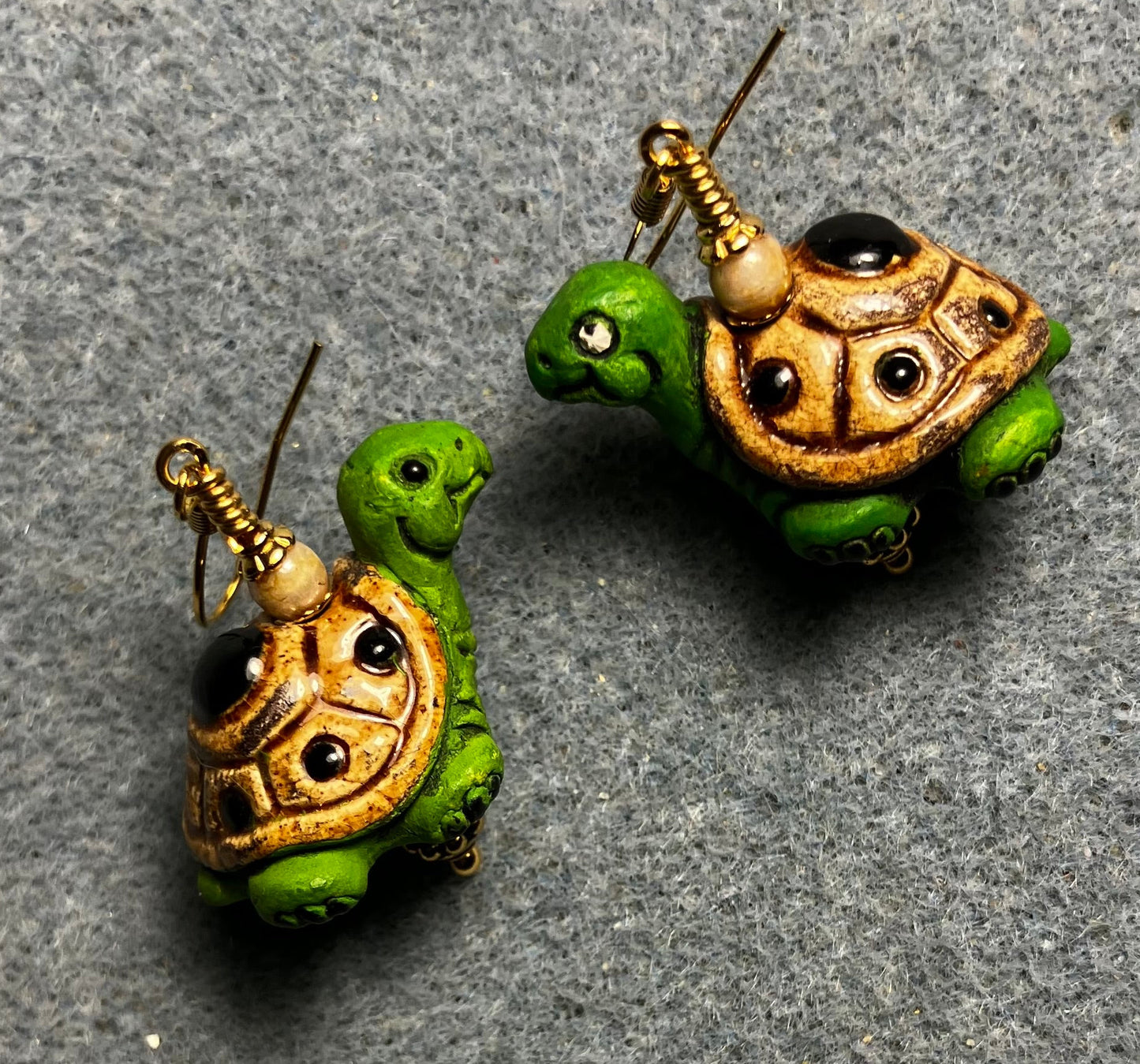 Green and tan ceramic turtle bead earrings adorned with tan Czech glass beads.
