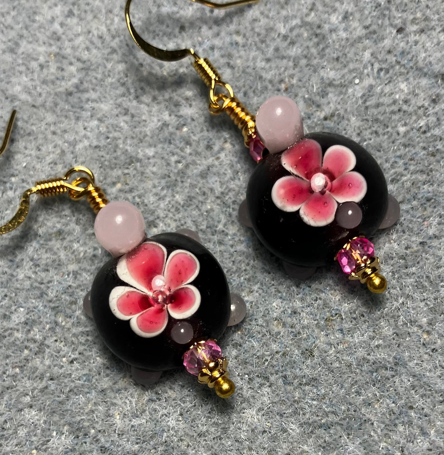 Dark red and pink lamp work turtle bead earrings adorned with hot pink Chinese crystal beads.