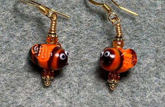 Small orange and black lamp work striped honeybee bead earrings adorned with orange Chinese crystal beads.