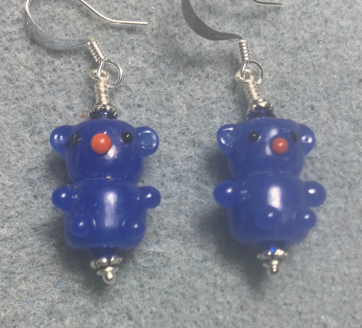 Small dark blue lamp work teddy bear bead earrings adorned with dark blue Chinese crystal beads.