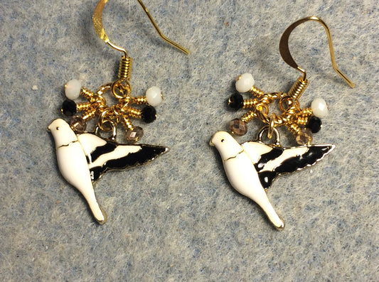 White, black, and gold enamel parakeet charm earrings adorned with tiny dangling white, black, and gold Chinese crystal beads.