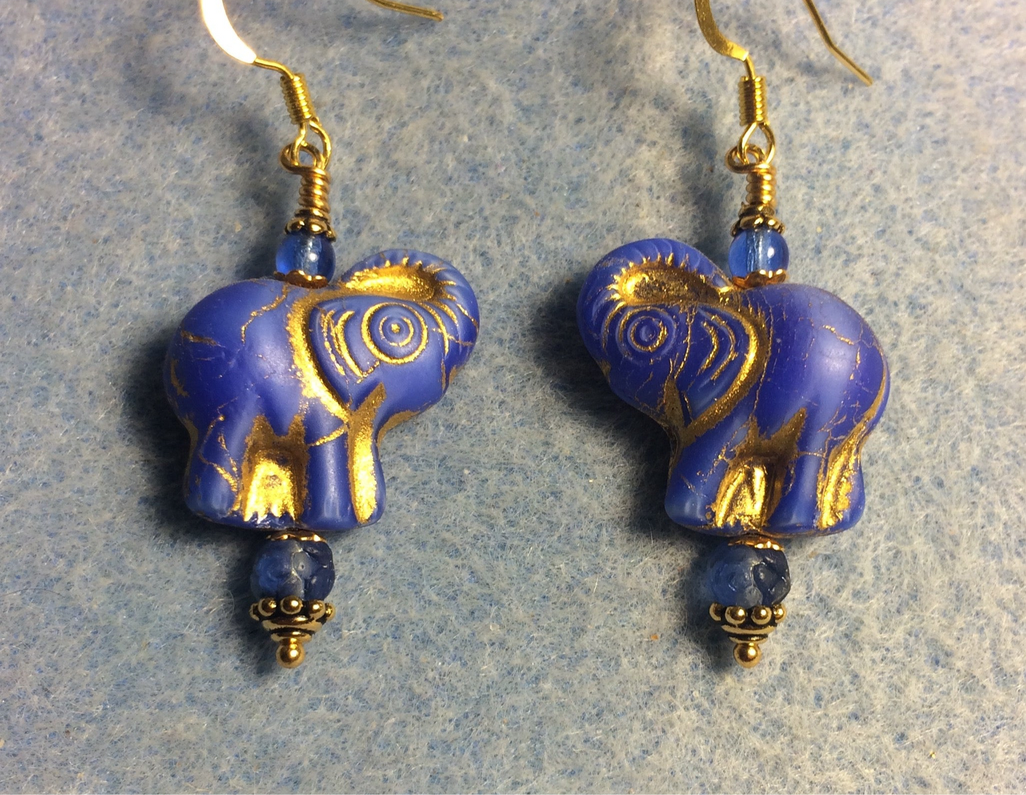 Bright blue (with gold inlay) Czech glass elephant bead earrings adorned with bright blue Czech glass beads.