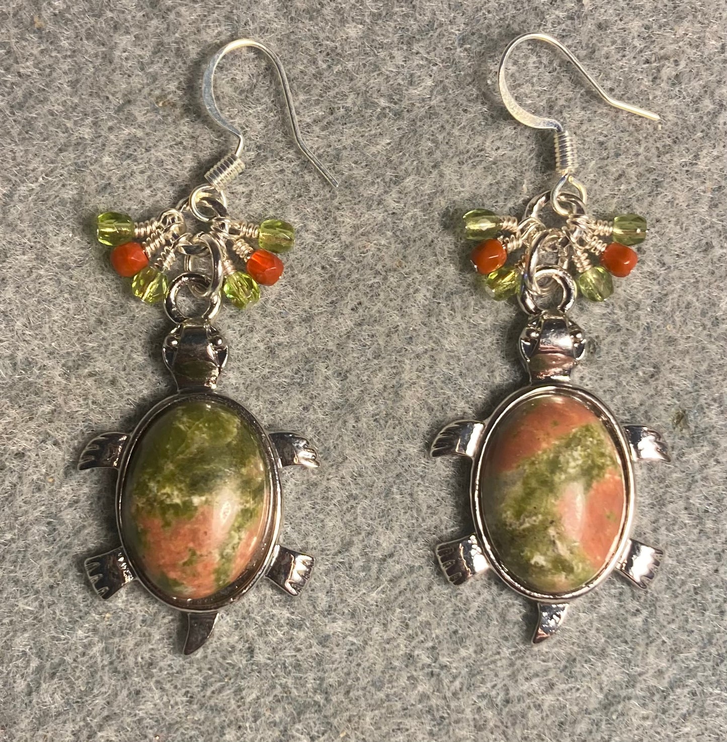 Large silver and green and orange unakite gemstone turtle charm earrings adorned with small dangling olive green and orange Czech glass beads.