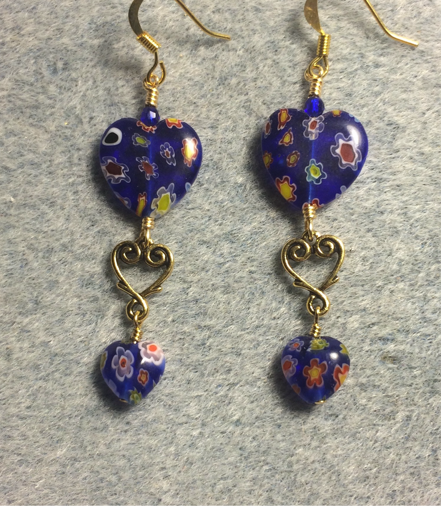 Large and small matching dark blue millefiori glass heart bead earrings joined by gold Tierracast heart connectors.