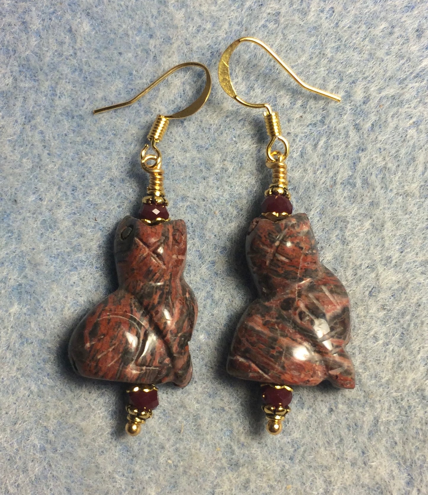 Reddish leopard skin jasper gemstone cat bead earrings adorned with dark red Chinese crystal beads.