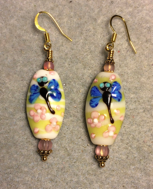 Blue, yellow, and pink lamp work dragonfly bead earrings adorned with pink Czech glass beads.